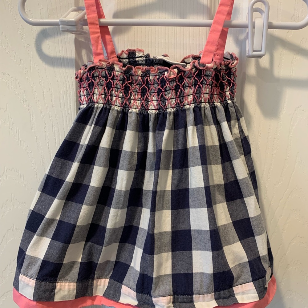 Three Hanna Andersson dresses with matching shirts and matching pink hat